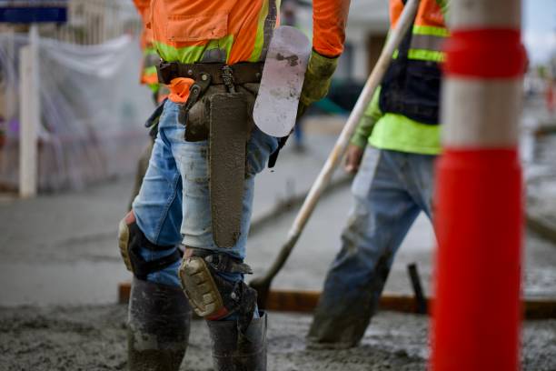 istock Road crew pouring wet concrete 2172537681