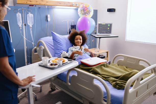 istock Nurse giving lunch to her little patient 2172539241