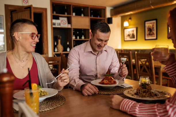 istock Group of friends eating together in a restaurant 2172541521
