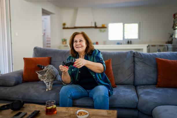 istock Senior woman playing computer games at home 2172541613