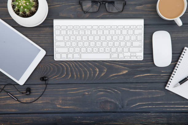 workspace with tablet, keyboard, coffee cup and eyeglasses copy space on  background. Top view.