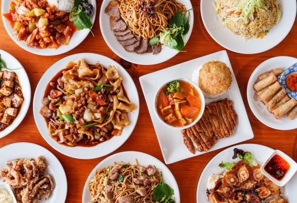 istock Beef  Noodles, pork with curry and rice, chicken spring rolls and seafood on table. 2172544254