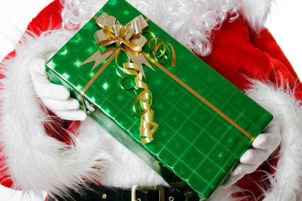 Close-up of Santa's hands holding a present.