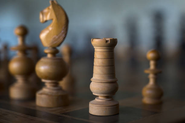 Wooden white Rook on a chess board