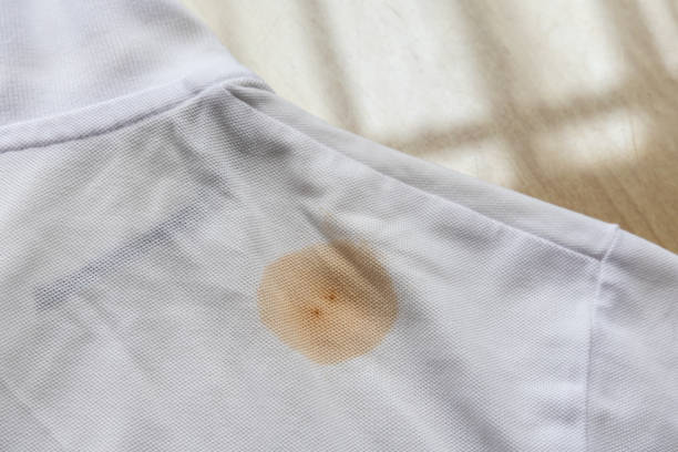 istock Brown stain on white t-shirt laid on table before laundry 2172546244