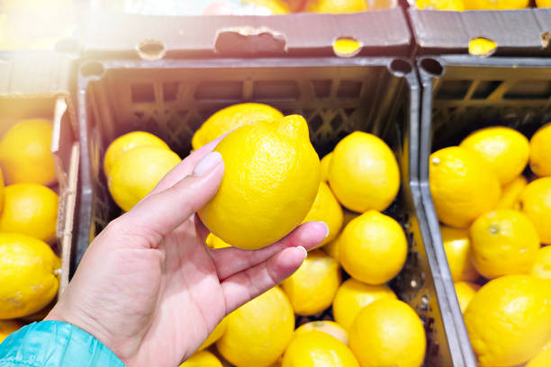 istock Lemon in hand in shop 2172546283