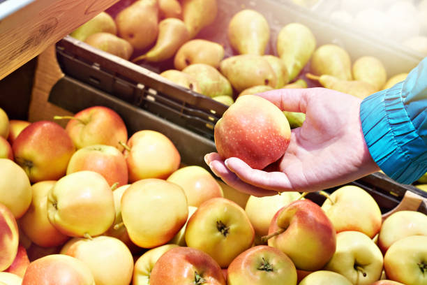 istock Apple in hand in market 2172546360