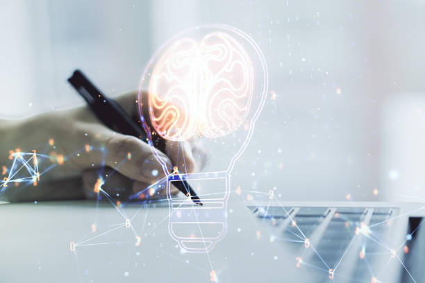 istock Creative light bulb illustration with human brain and hand writing in diary on background with laptop, future technology concept. Multiexposure 2172546945