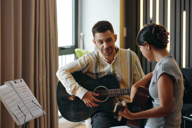 istock Sharing Musical Moment While Playing Acoustic Guitars 2172547371