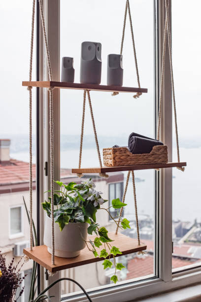 istock Rustic Window Shelving: DIY Rope Hanging Organizer with Indoor Plants, Smart Devices, and Storage Basket - Coastal Home Decor with City View 2172549301