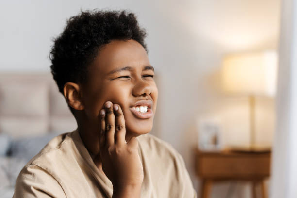 istock Upset handsome African American boy touching cheek, having toothache 2172551264