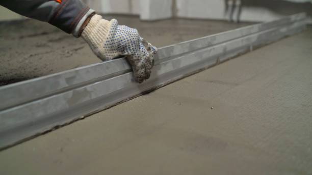 istock A smooth mortar is laid on the floor. Concrete cement is half wet and half dry. 2172551950