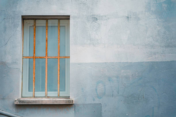 istock Used Clean Blue Plaster Pastel Wall with  Window with Fencing 2172551959