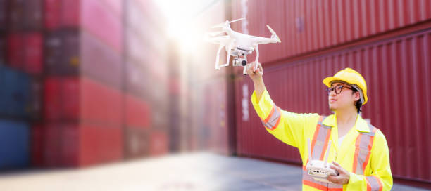 istock Logistic engineer is flying drone around container yard for daily inspecting. 2172552547