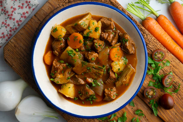 istock Beef stew with potatoes and artichoke. Top view table with  decoration. 2172552740