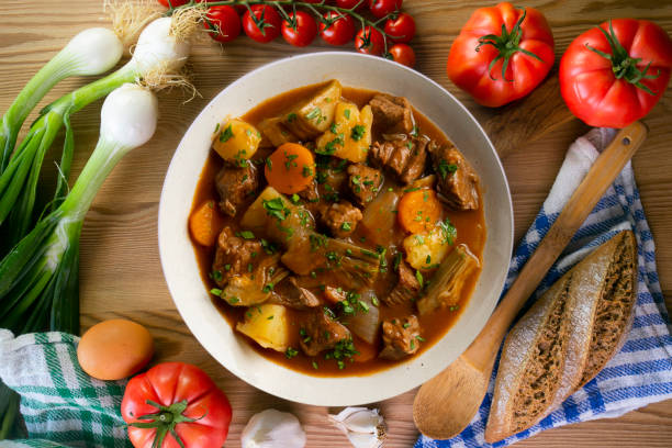 istock Beef stew with potatoes and artichoke. Top view table with  decoration. 2172552753