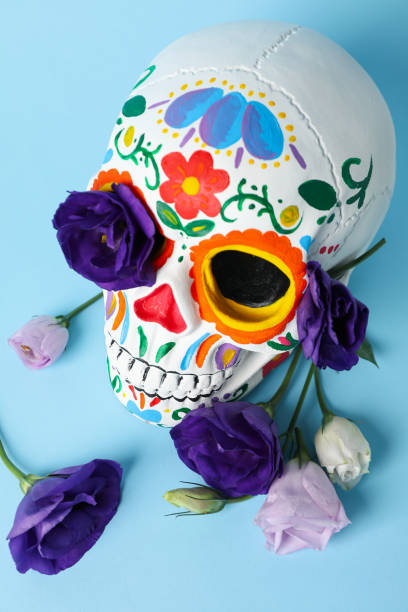 istock Mexican skull and flowers on blue background, close up 2172553756