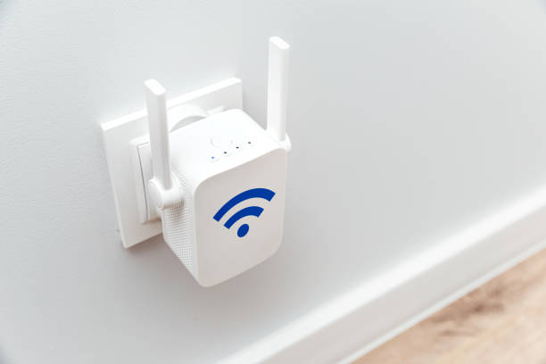 istock Wireless Wi-Fi repeater on white wall indoors 2172555940