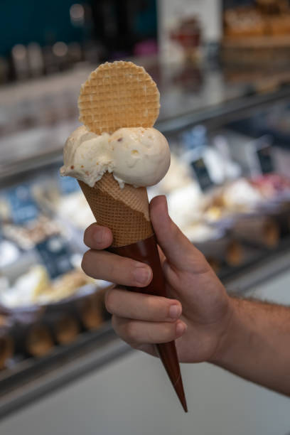 istock hand holding chocolate ice cream cone close up isolated 2172557019