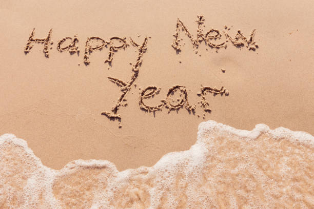 istock inscription happy new year on the seashore 2172558430