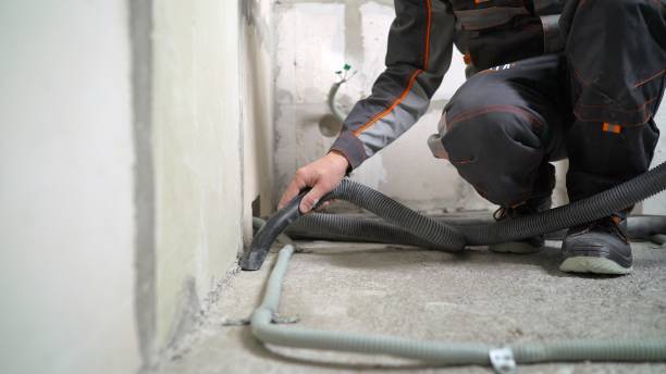 istock A worker vacuums a concrete floor. Worker washes the floor with a vacuum cleaner from industrial concrete dust and cement mud during home renovation 2172559548