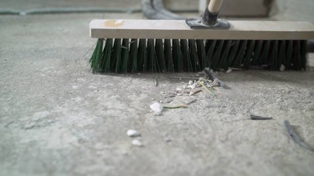 istock Primer for concrete floor. The master lays liquid soil on a concrete floor. Primer worker on concrete floor. Primer floor protection in a new room 2172559666