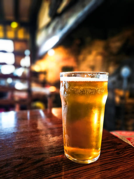 istock Pint of beer on table in traditional British pub 2172559849
