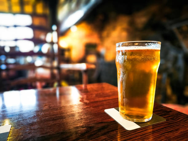 istock Pint of beer on table in traditional British pub 2172559852