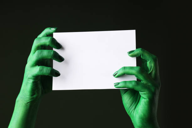 istock Green, painted hands hold a letter for text. 2172560229