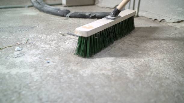 istock Primer for concrete floor. The master lays liquid soil on a concrete floor. Primer worker on concrete floor. Primer floor protection in a new room 2172560416