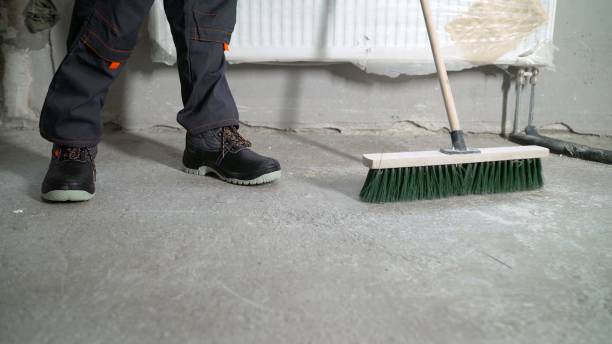 istock Worker cleaning industrial dirt. Worker with a floor brush. 2172560722