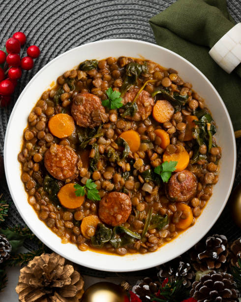 istock Lentil stew with chorizo, spinach and carrot. Top view table with Christmas decorations. 2172561707