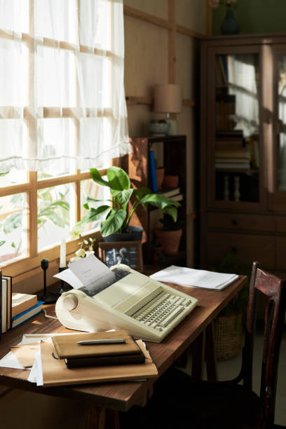 istock Desk With Retro Computer and Papers in Cozy Workspace 2172564489