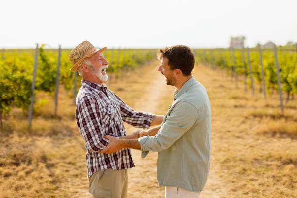 istock Heartfelt conversation between two generations in a sunlit vineyard during late afternoon harvest season 2172564800