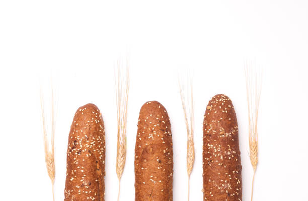 istock Rye buns, mini baguettes with ears of wheat on a white background 2172565155