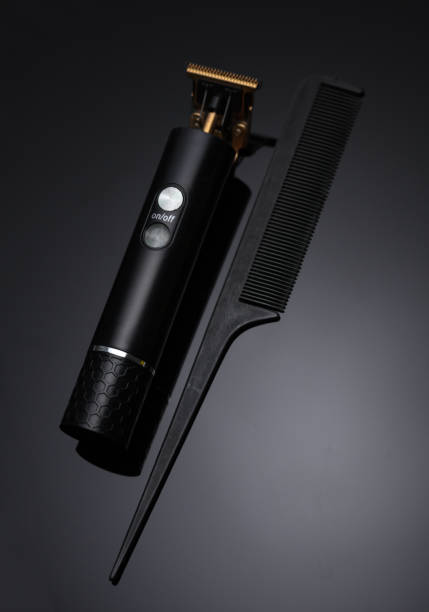 istock Electric trimmer and comb on a black background 2172565297