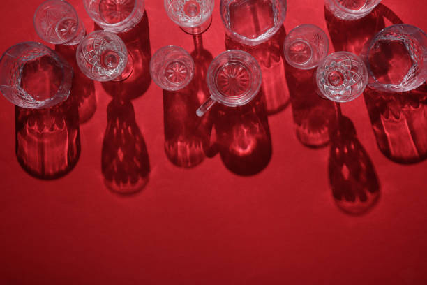 Drink glasses with shadow on red background. Top view. Minimalism, creative layout