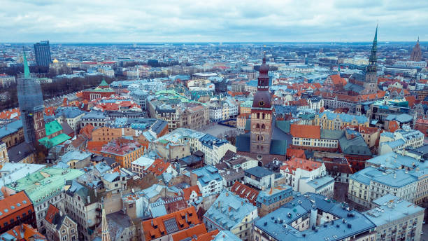 Riga's vibrant skyline showcases a tapestry of historic buildings, winding streets, and colorful rooftops, creating a unique urban landscape under overcast skies.
