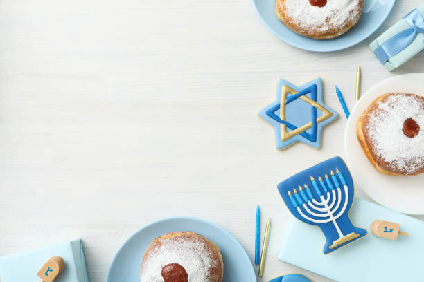 istock Gingerbread cookies and donuts on white wooden background, space for text 2172566647