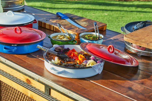istock A colorful dish with roasted vegetables including bell peppers, zucchini, red cabbage, and onions placed in a vibrant red pot on a wooden table 2172567842