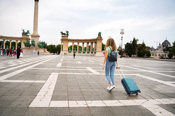 istock A wanderer exploring Heroes' Square in Budapest with a suitcase, soaking in the historic atmosphere of this magnificent landmark 2172570161