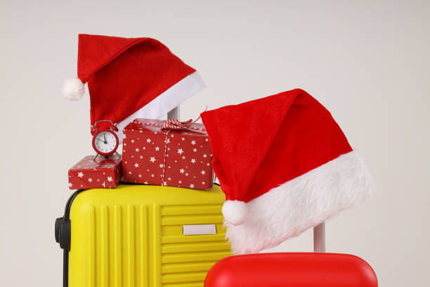 istock Suitcases with a New Year's hat and gifts 2172570739