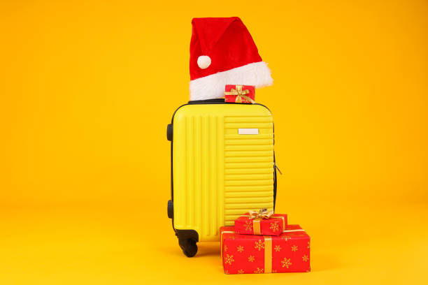 istock A suitcase with a New Year's hat and gifts 2172571613