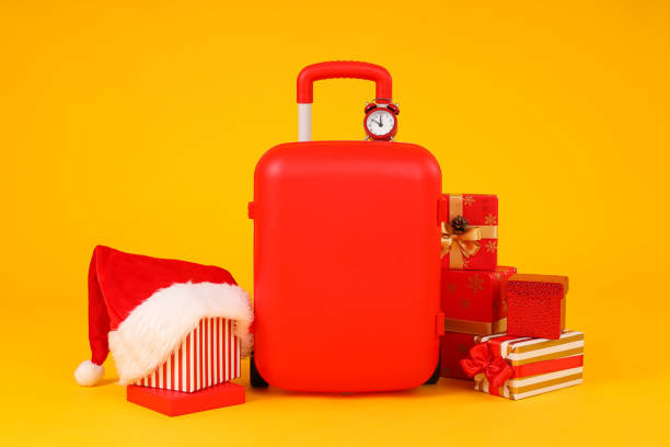 istock A suitcase with a New Year's hat and gifts 2172571710