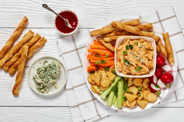istock buffalo chicken dip with veggie and bread sticks 2172571996
