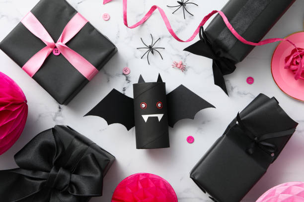istock Black, paper bat with gifts for Halloween 2172573536