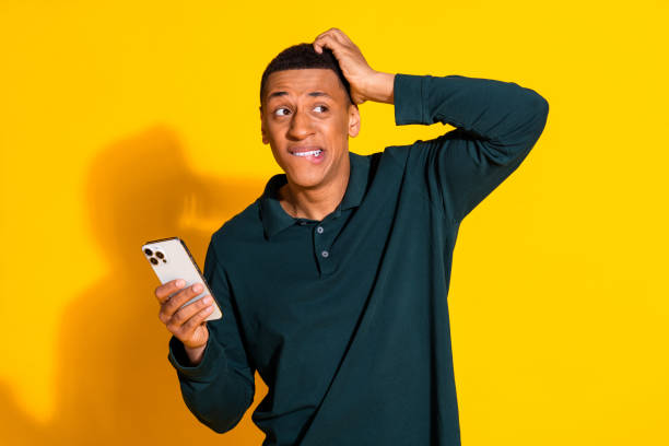 istock Photo of nice young man hold phone look empty space ponder wear pullover isolated on bright yellow color background 2172573555