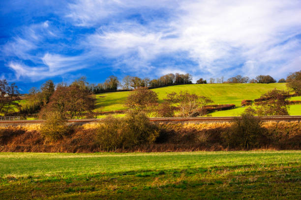 . A view of a farm  and agriculture near Henley in Arden midlands england uk. It is a warm sunny day in Spring and there are no visible people in the picture.