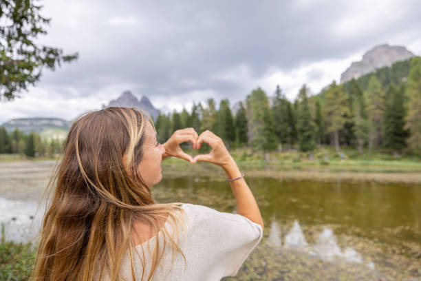 istock Woman Forming Heart Shape with Hands, Admiring Nature 2172574948