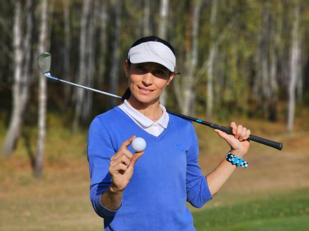 istock A golfer on the course confidently holds a golf ball 2172575239
